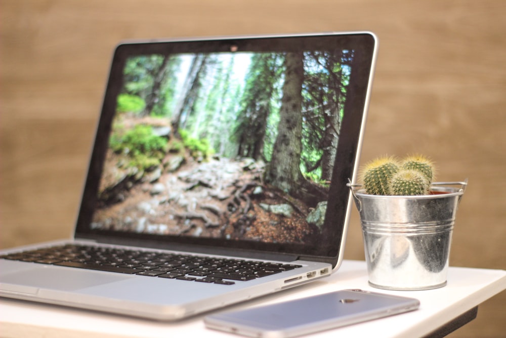 macbook pro beside silver iphone 6 on table