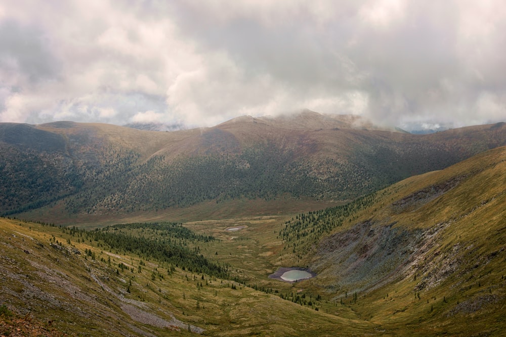 green mountains under white clouds during daytime