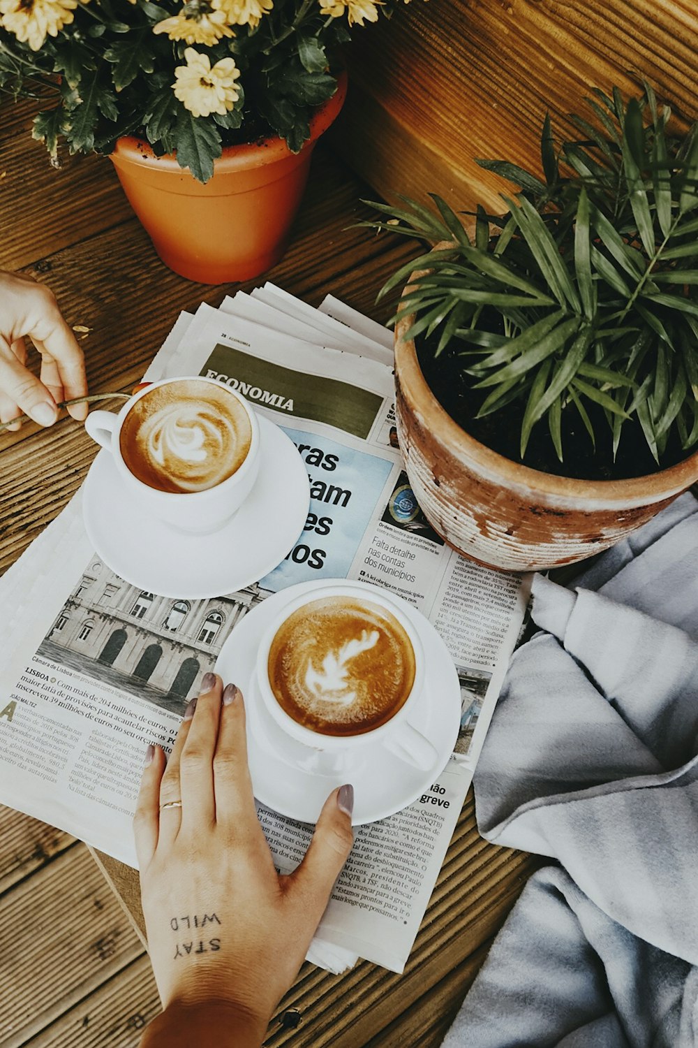 person holding white ceramic mug with coffee