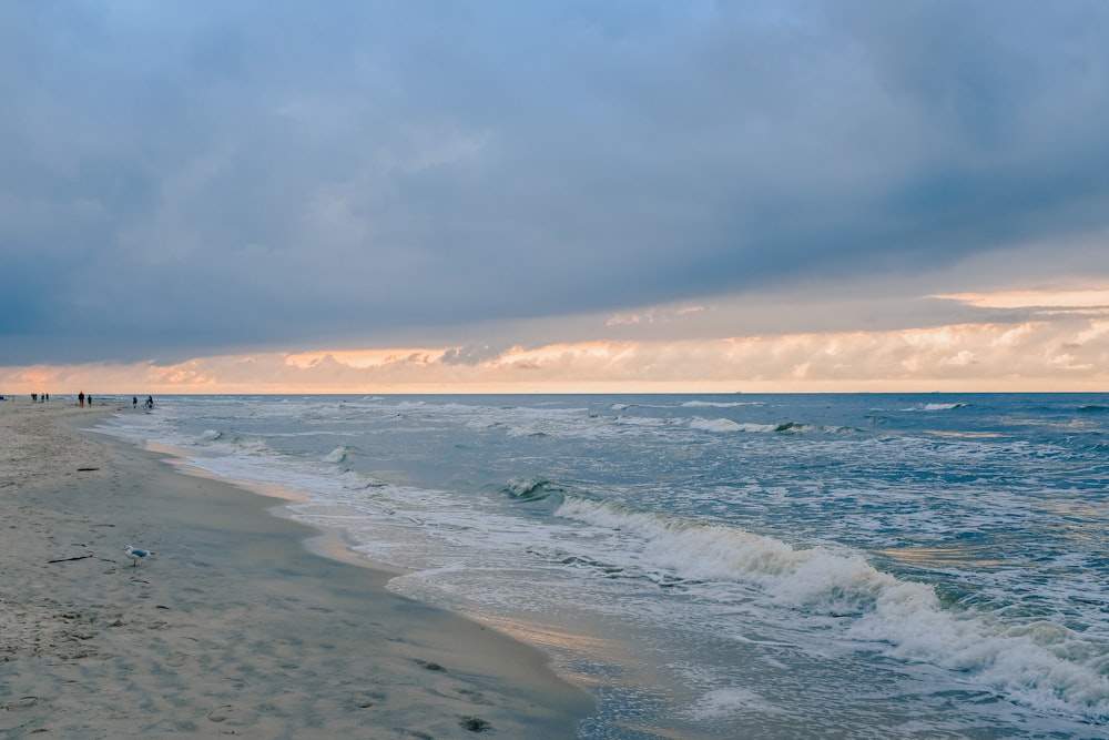 ocean waves crashing on shore during daytime