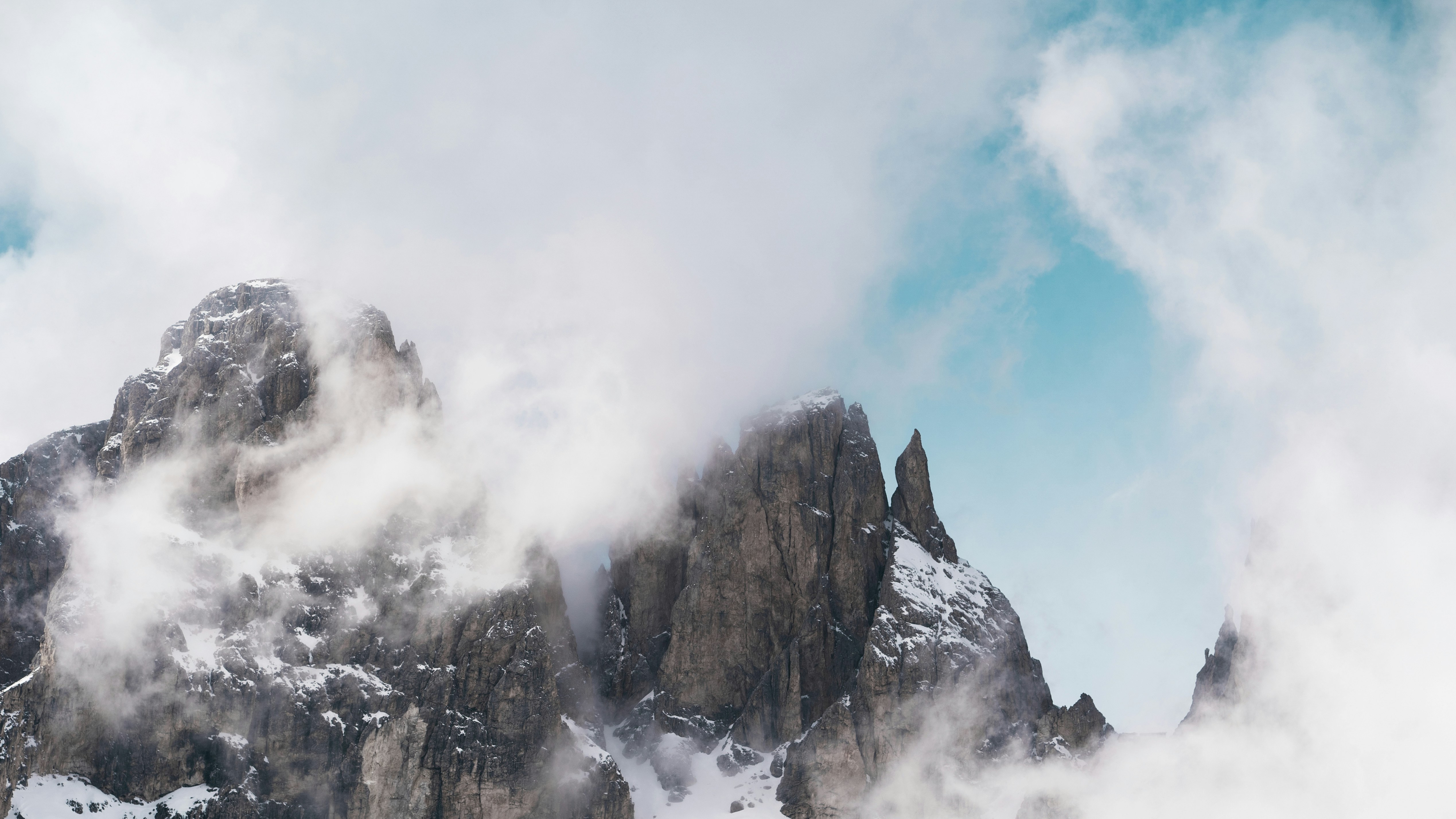 brown rocky mountain under white clouds during daytime