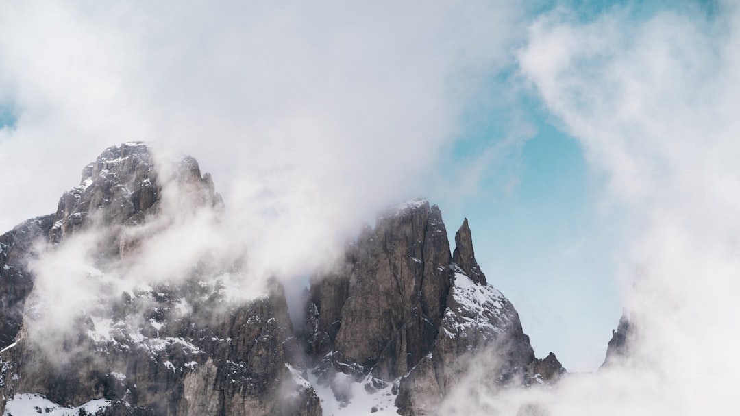 brown rocky mountain under white clouds during daytime