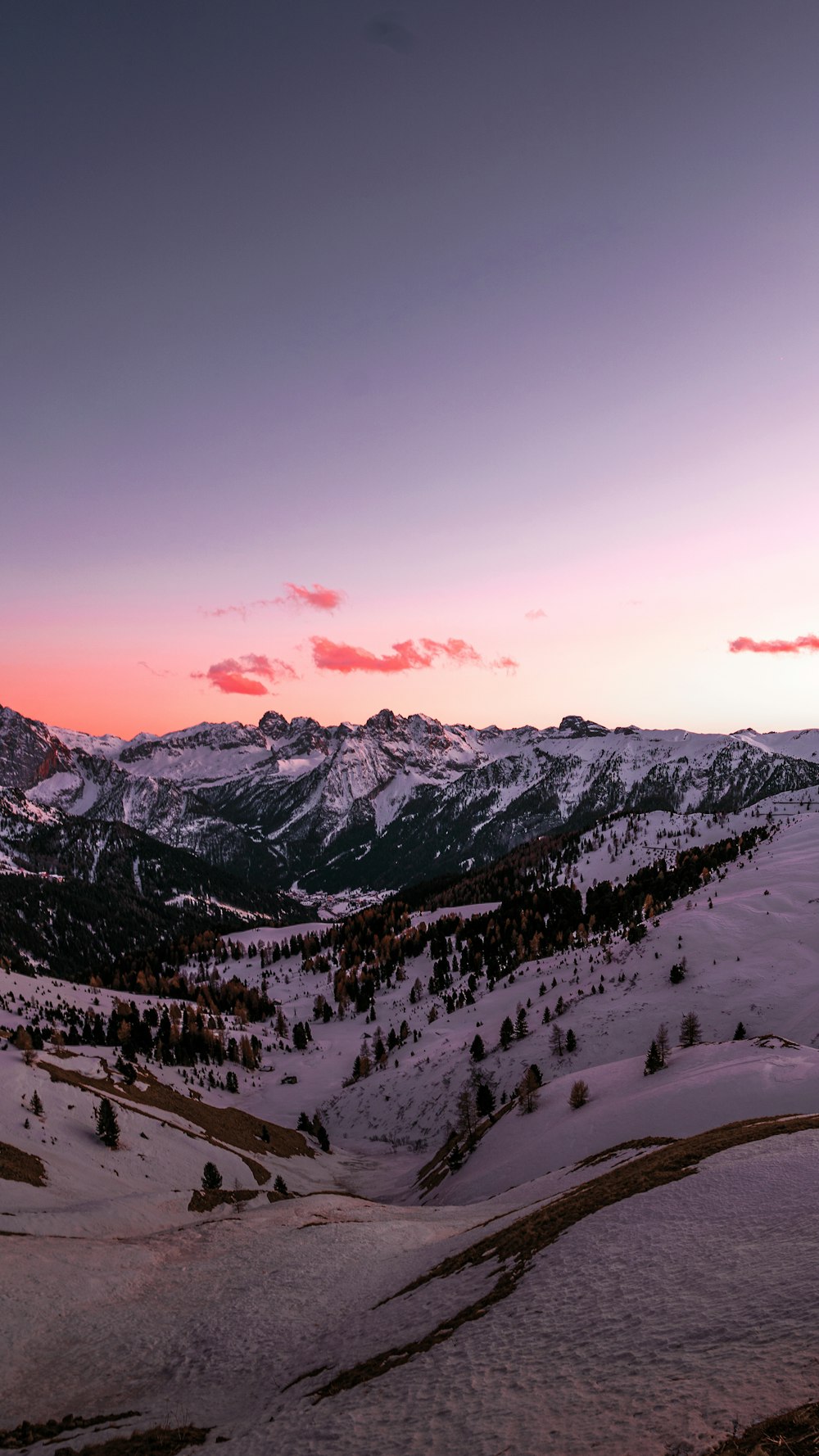 snow covered mountain during sunset