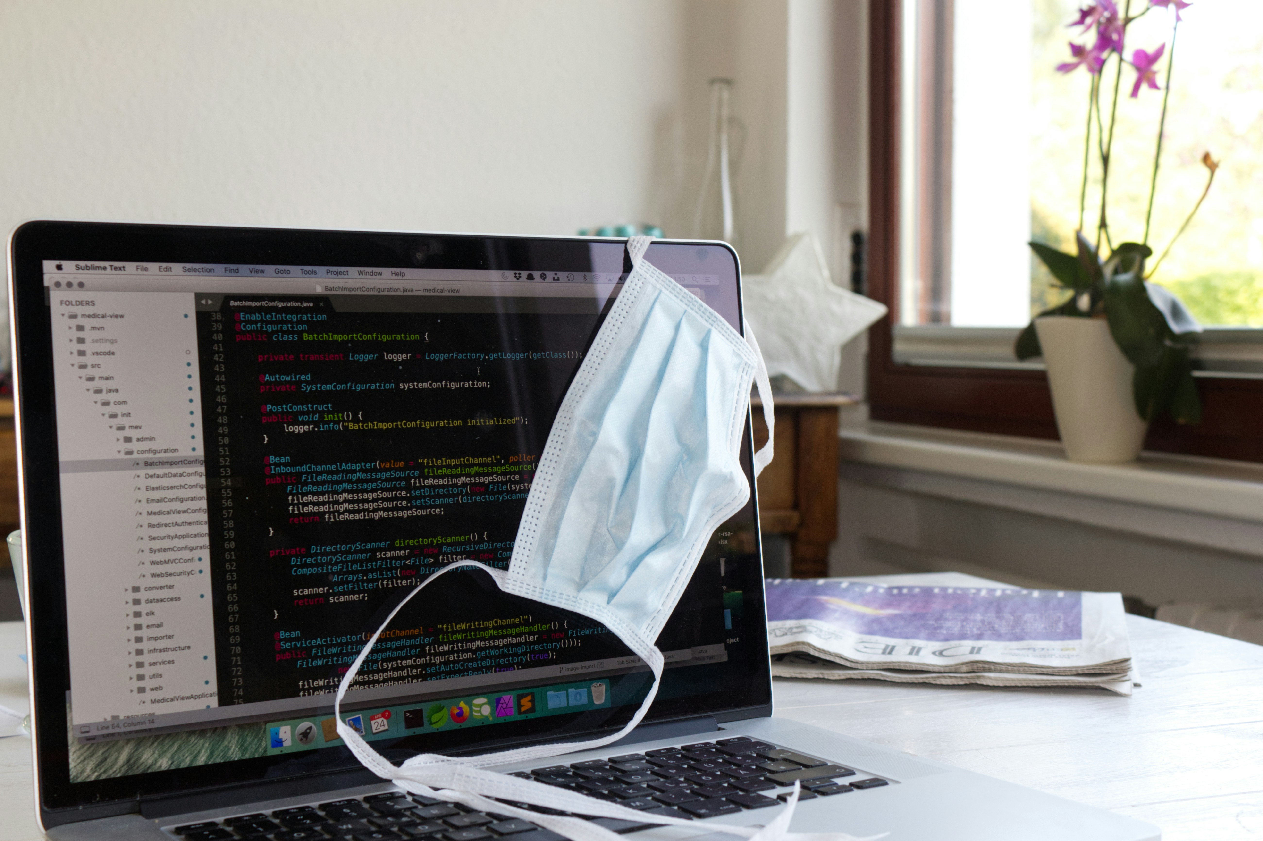 white laptop computer on white table