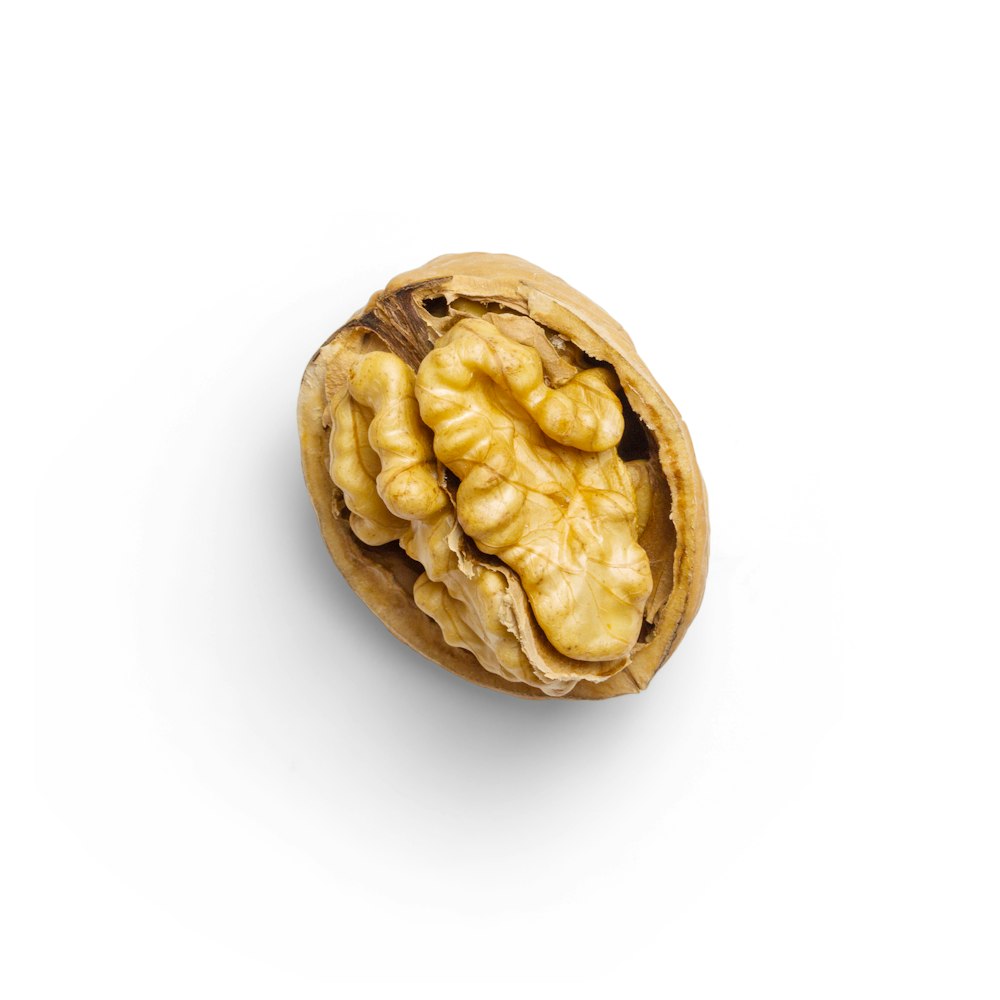 brown nut on white surface