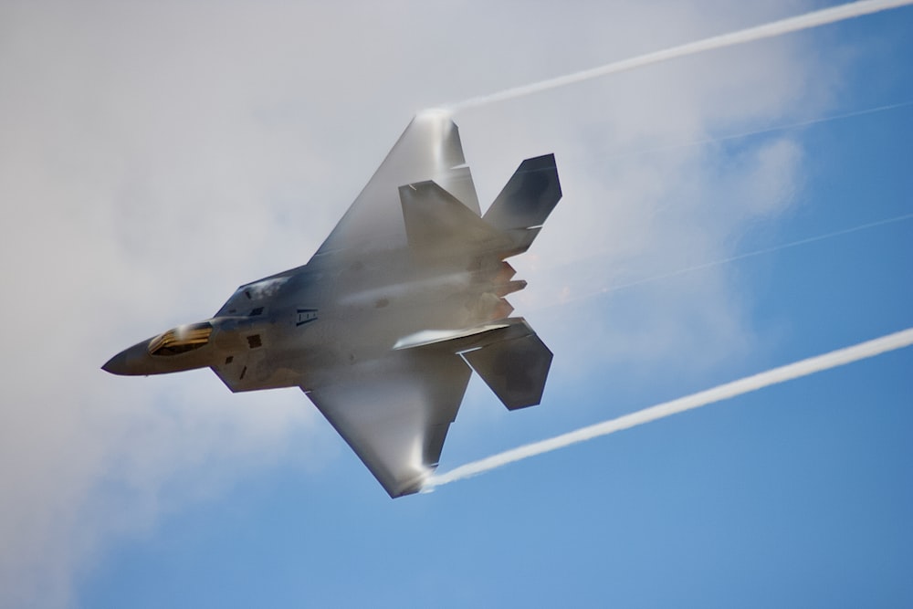 black jet plane in mid air during daytime