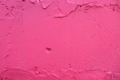 pink concrete wall during daytime pink teams background
