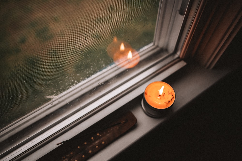 orange pumpkin on window during daytime