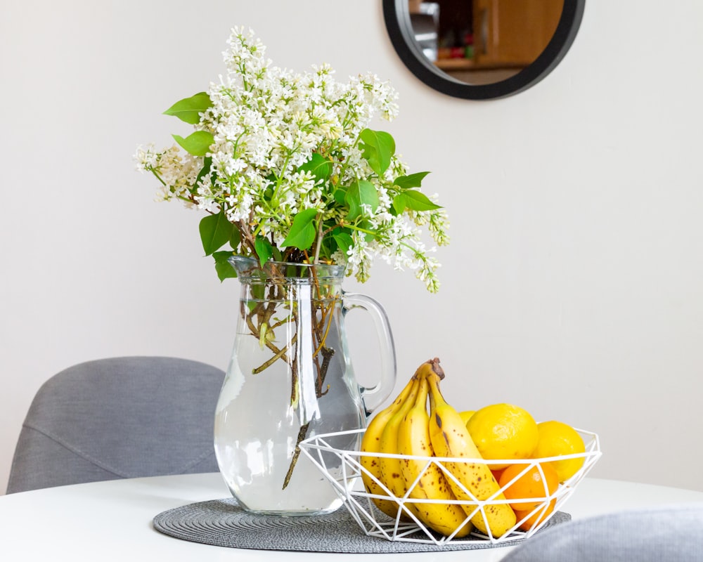 yellow fruit on clear glass vase