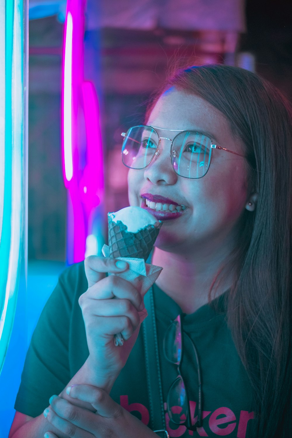 woman in green shirt holding ice cream cone