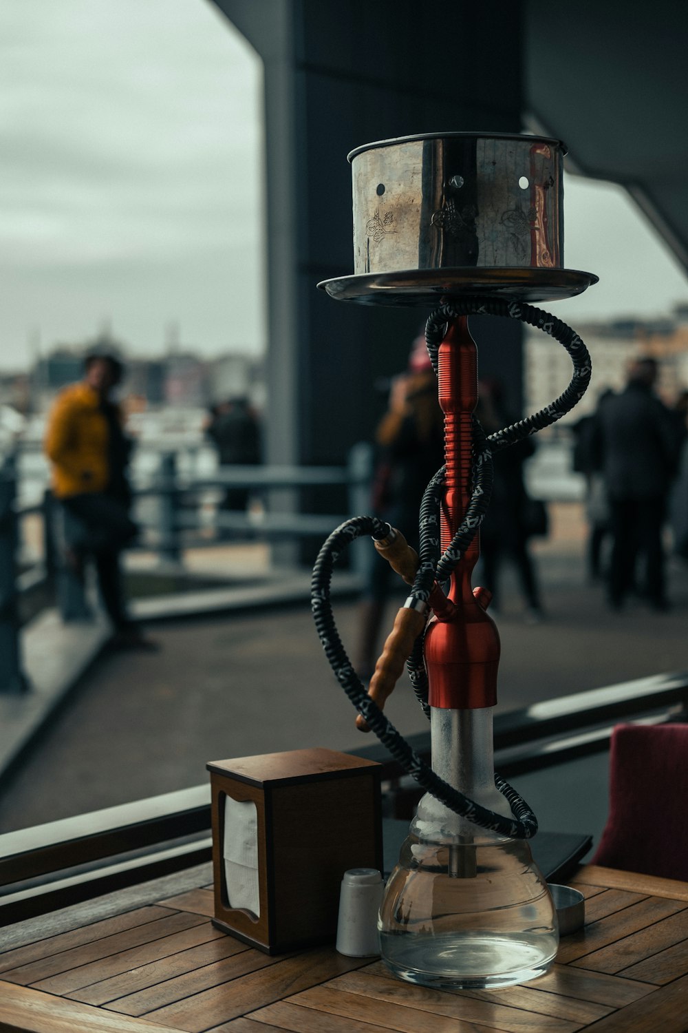 red and black hookah on brown wooden table