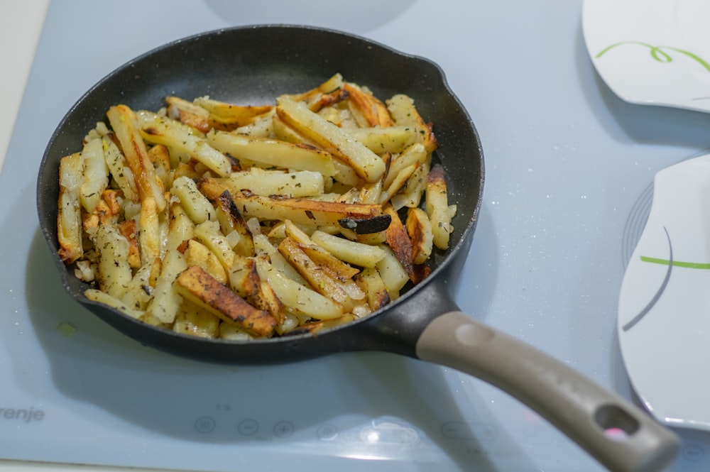 fried fries on black frying pan