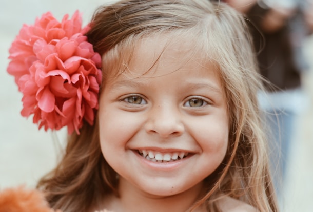 girl with red flower on her ear