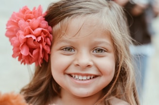 girl with red flower on her ear