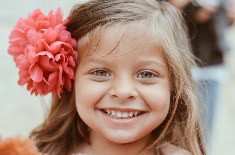 girl with red flower on her ear