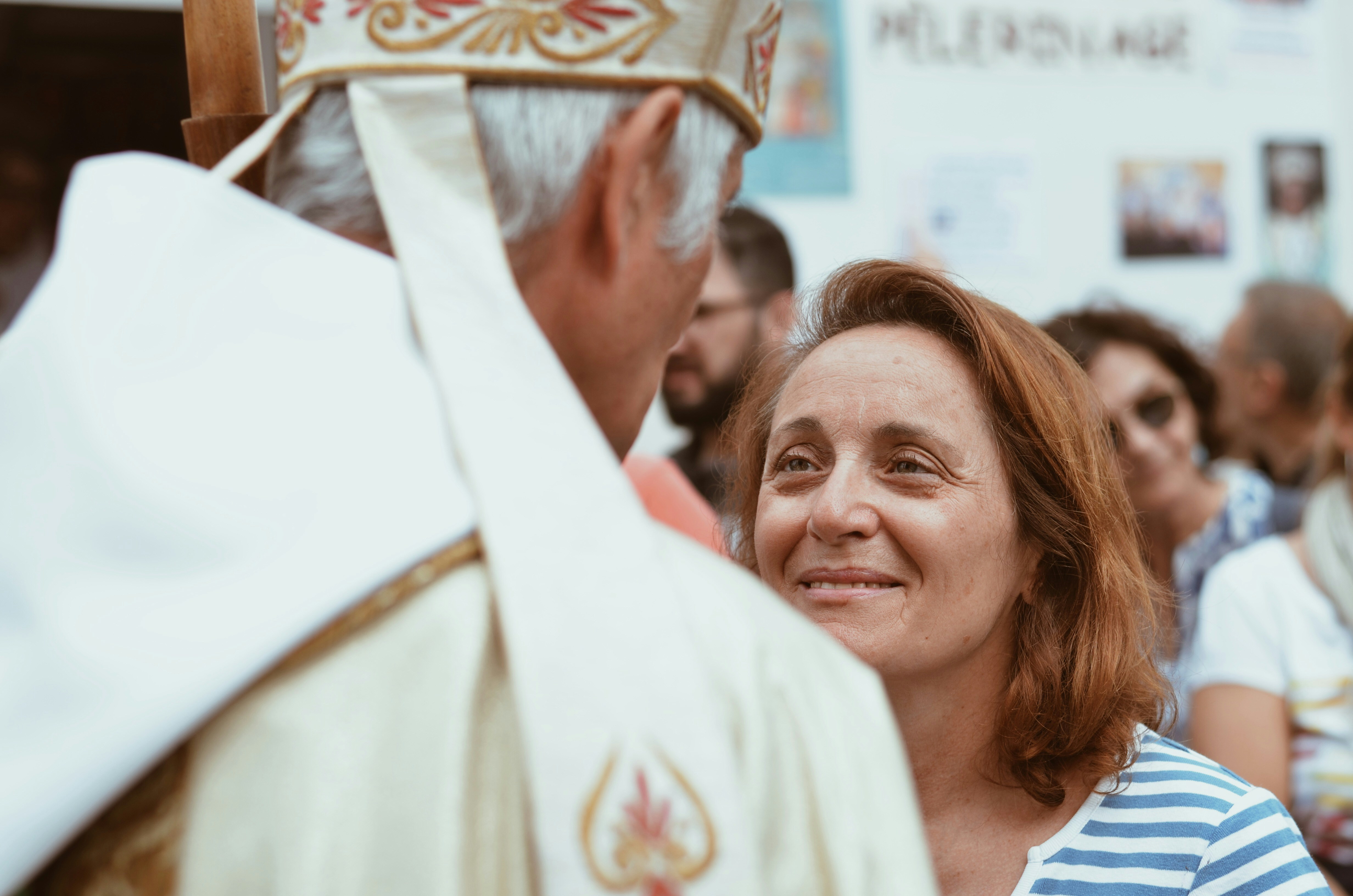 woman in white shirt smiling, Believer