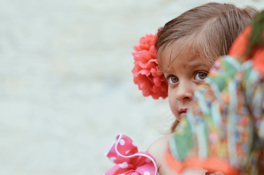 girl in teal tank top with red flower on her ear, Little bohemian girl