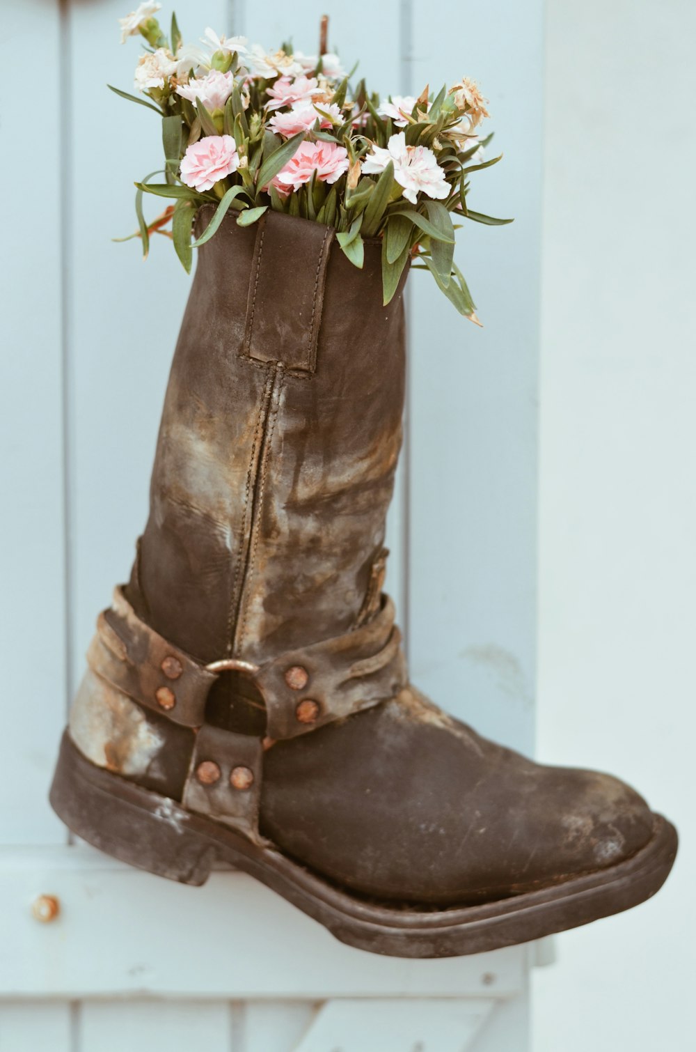 brown leather boots with green leaves