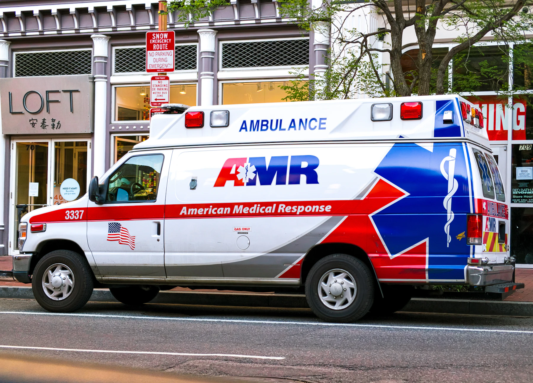 Ambulance with strobes at night — hero shot for landing page