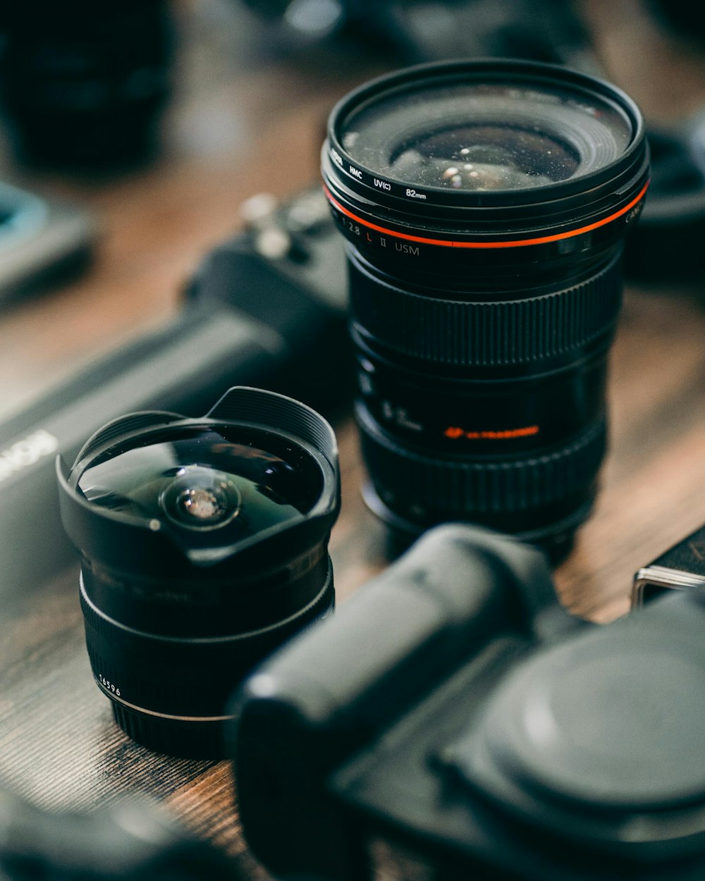 black camera lens on brown wooden table