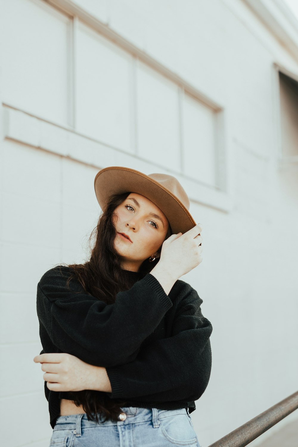 woman in black long sleeve shirt wearing brown fedora hat