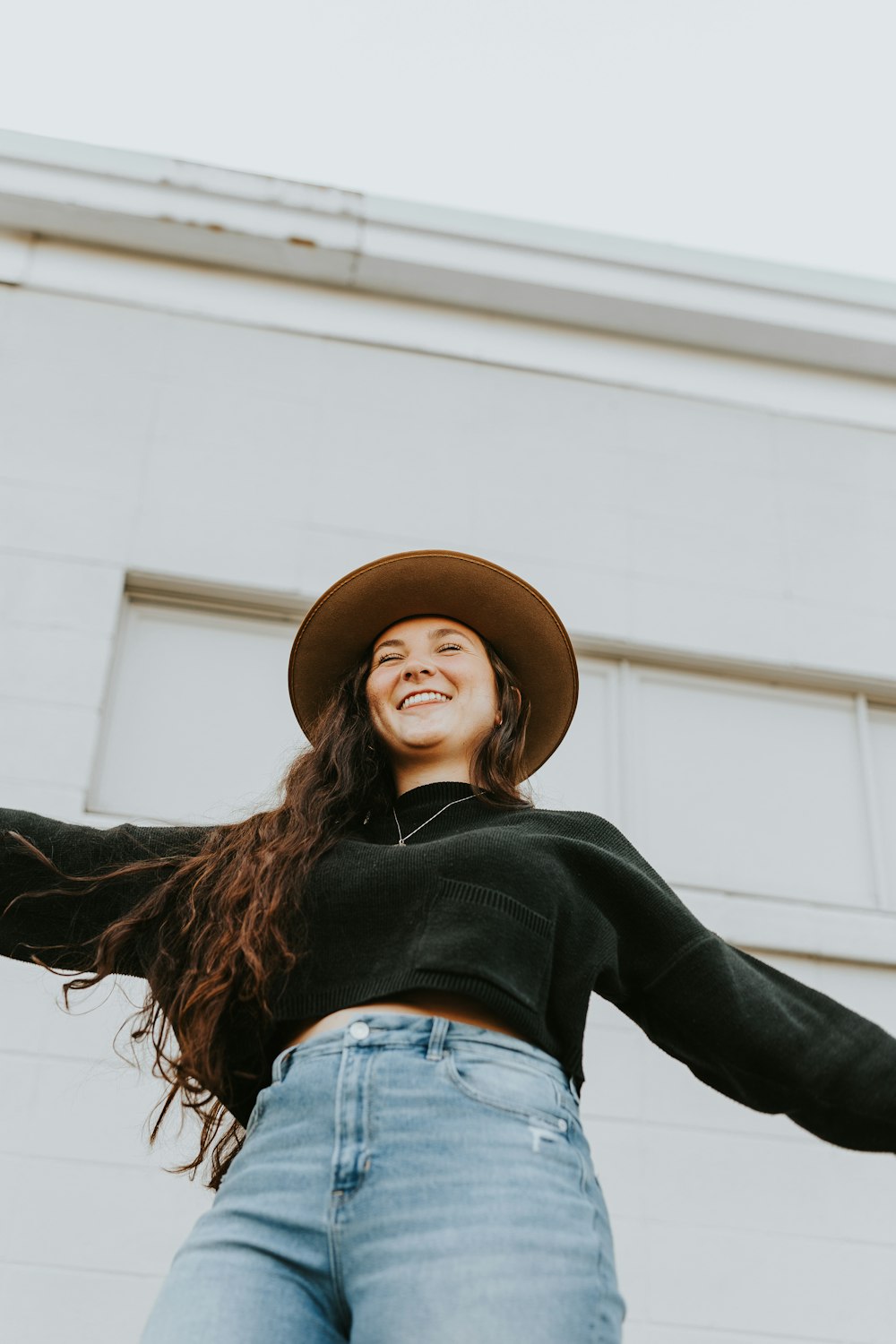 woman in black long sleeve shirt wearing brown hat