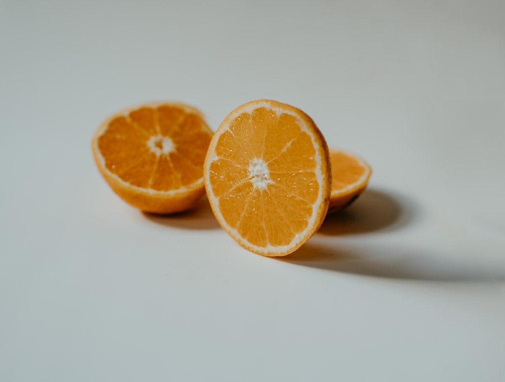 sliced orange fruit on white surface