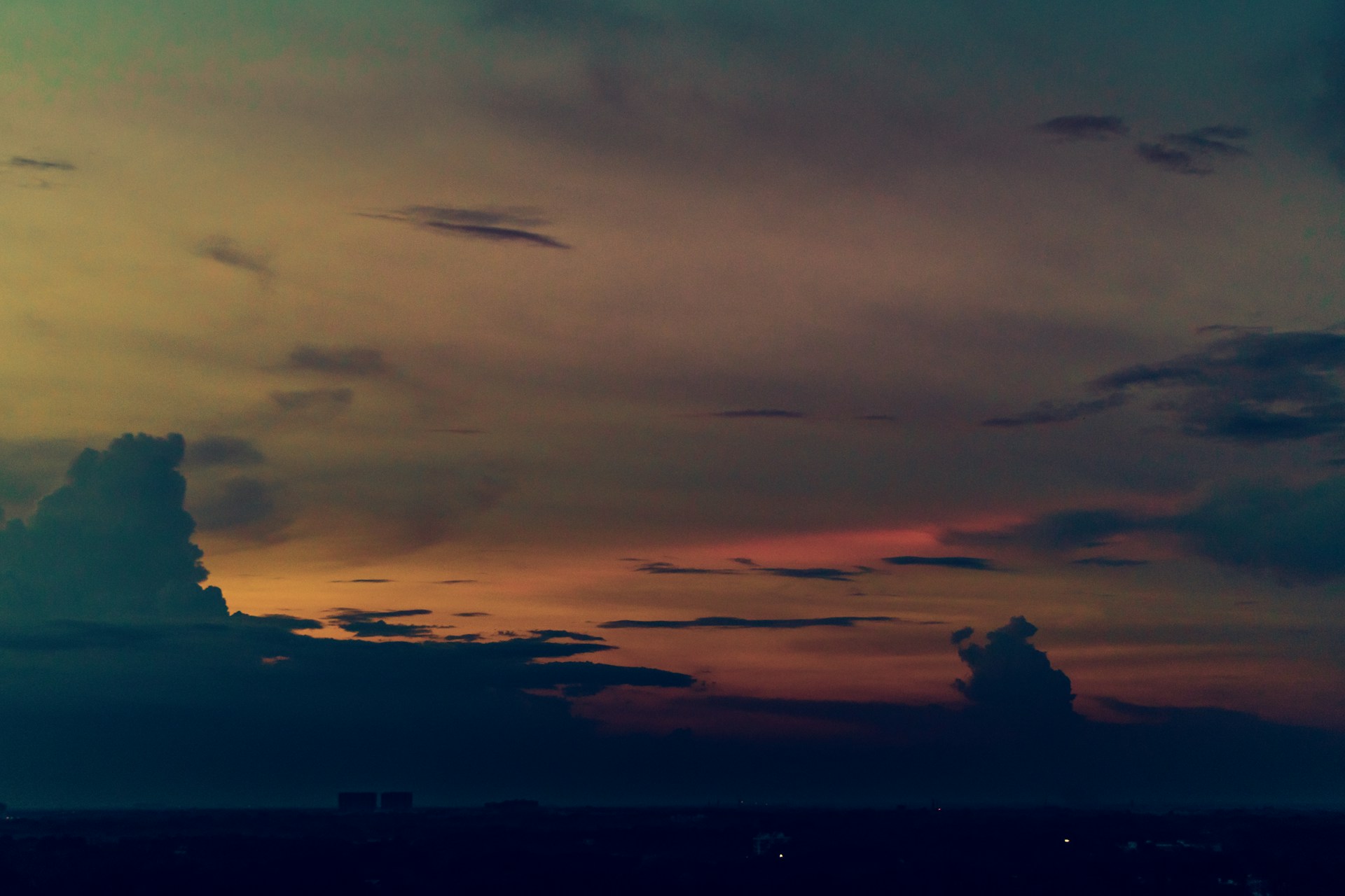 woman wearing yellow long-sleeved dress under white clouds and blue sky during daytime