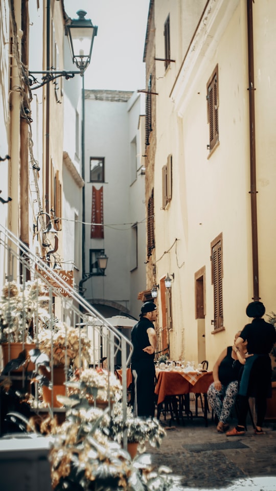 people walking on street during daytime in Sardinia Italy