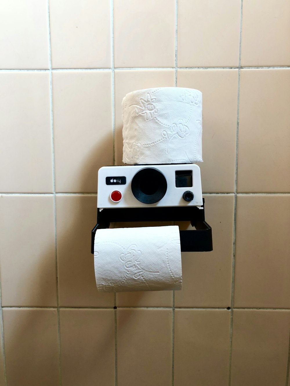 white toilet paper roll on black holder