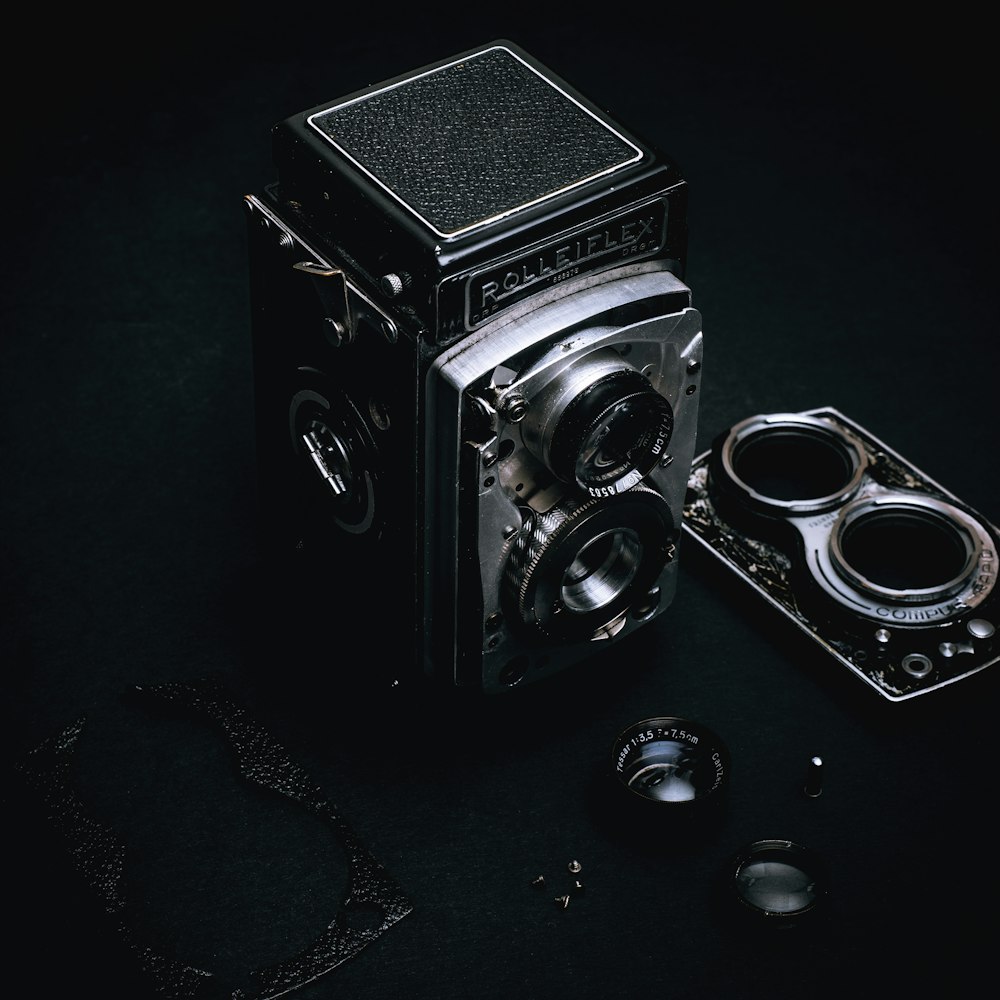 black and silver camera on black surface