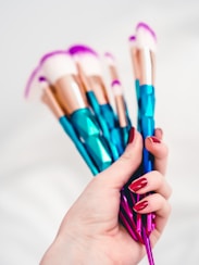 person holding blue and pink pen