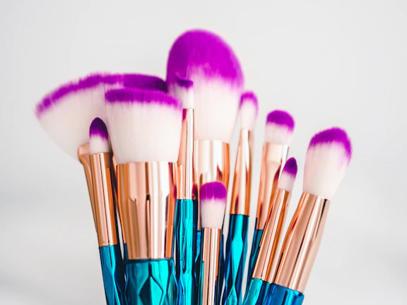 Editorial-style photo of a chic makeup brush set with muted lavender and blush accents.