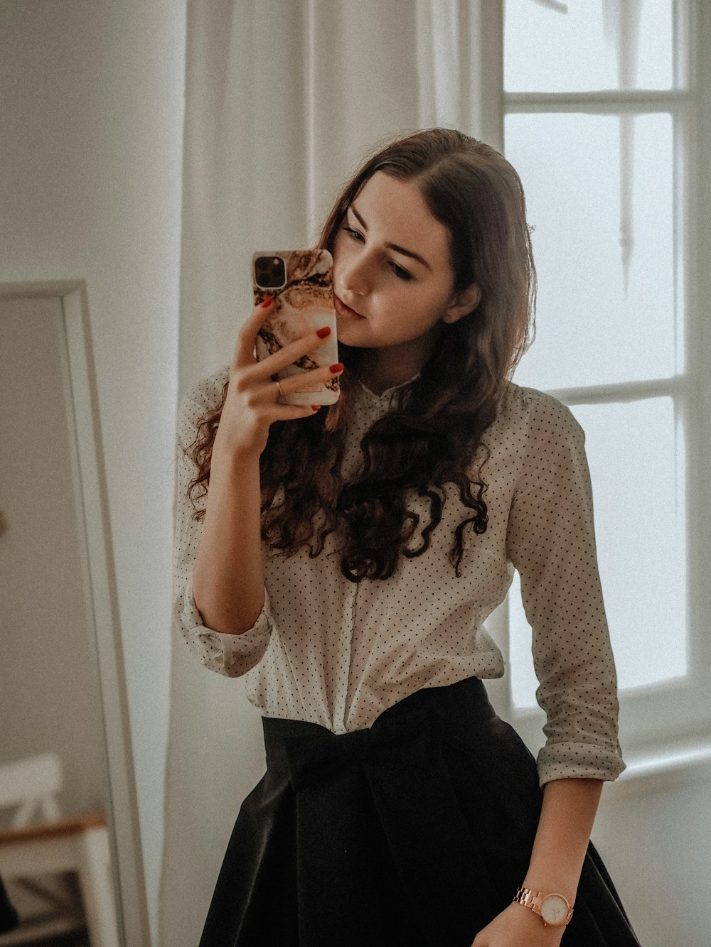 woman in white long sleeve shirt and black skirt