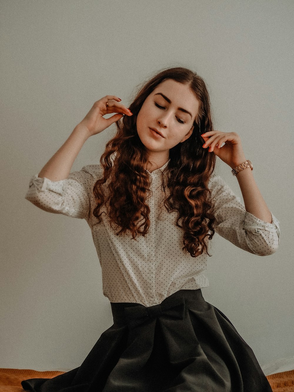 woman in white long sleeve shirt and black skirt