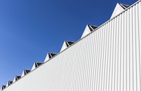 white and black concrete building under blue sky during daytime