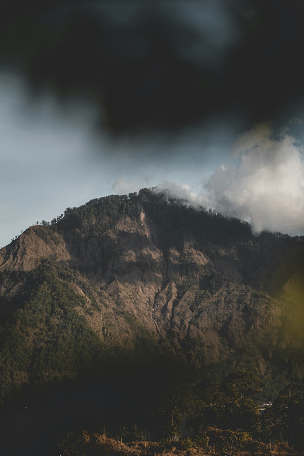 brown mountain under white clouds