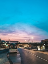 A sleek Eurostar Fretamento bus parked by the beach at sunset, ready for the next trip.