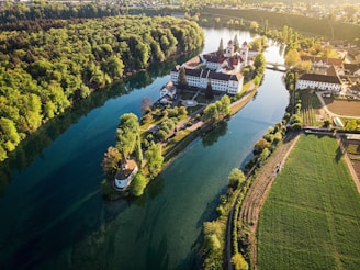 aerial view of green grass field near body of water during daytime