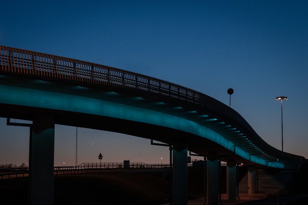 silhouette of people walking on bridge during night time