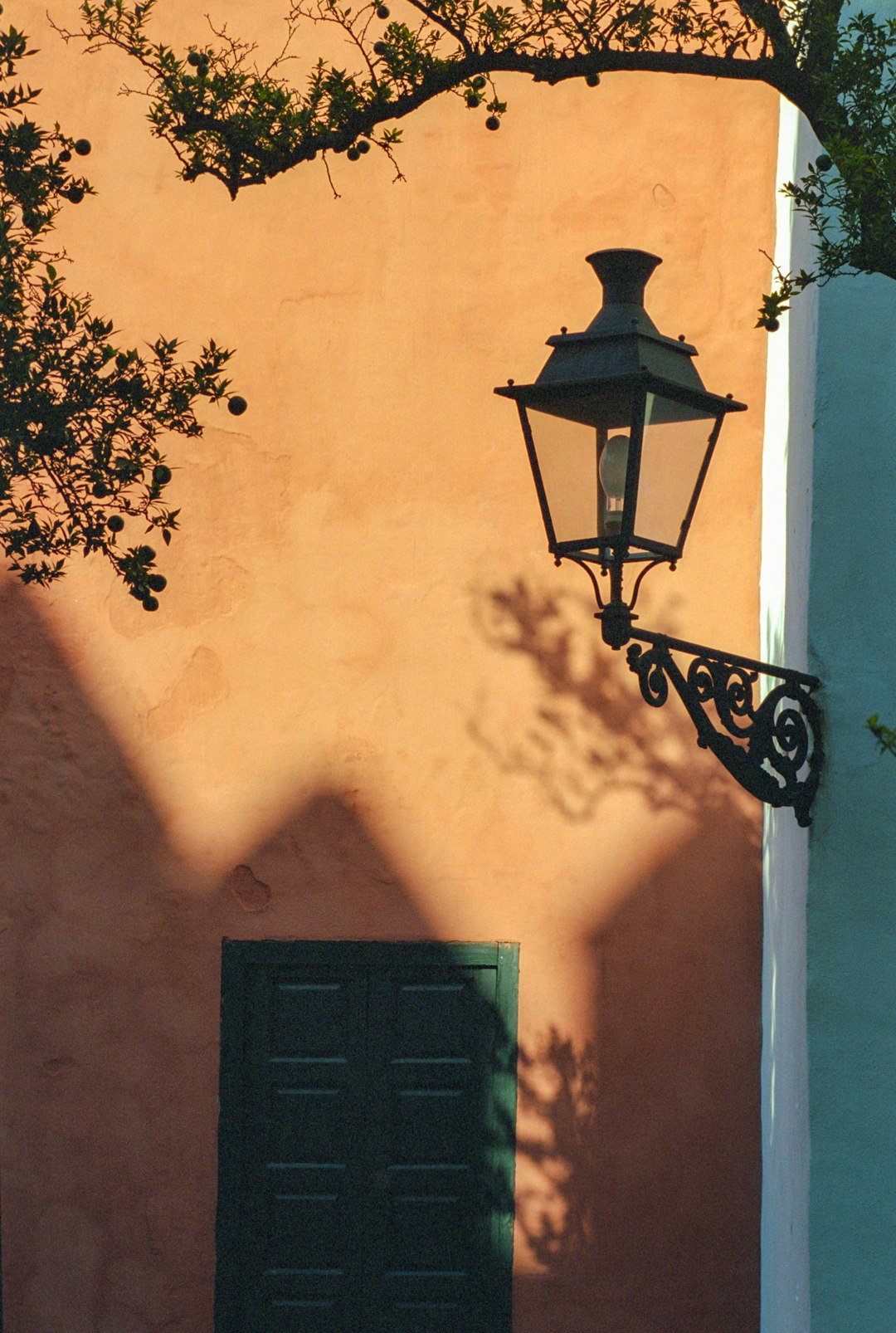 black sconce lamp on yellow painted wall