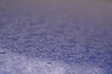 Close-up of a water droplet beading on a treated paper surface.
