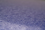 Macro shot of water droplets beading on a treated paper surface.