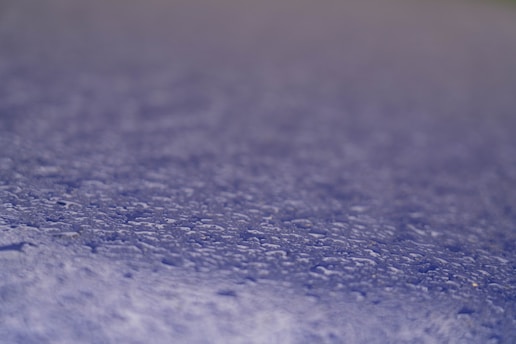 Close-up of water droplets beading on a treated paper surface