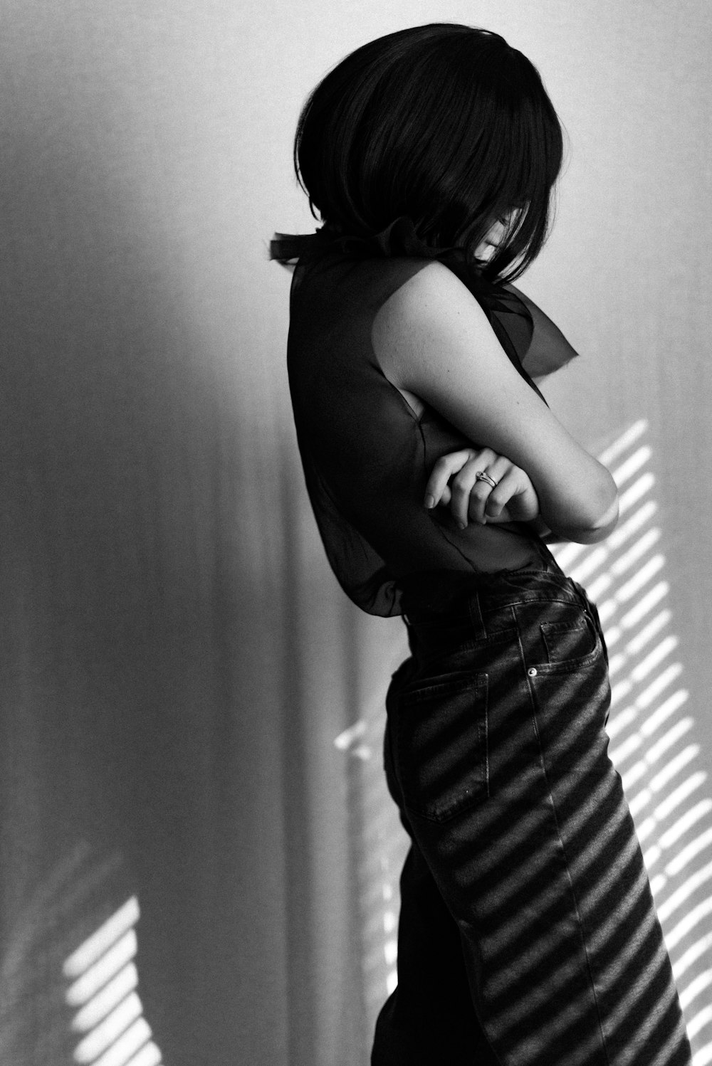 grayscale photo of woman in black and white stripe dress