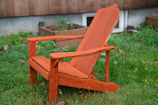 Outdoor scene featuring the aluminum Adirondack chair beside a blooming garden.