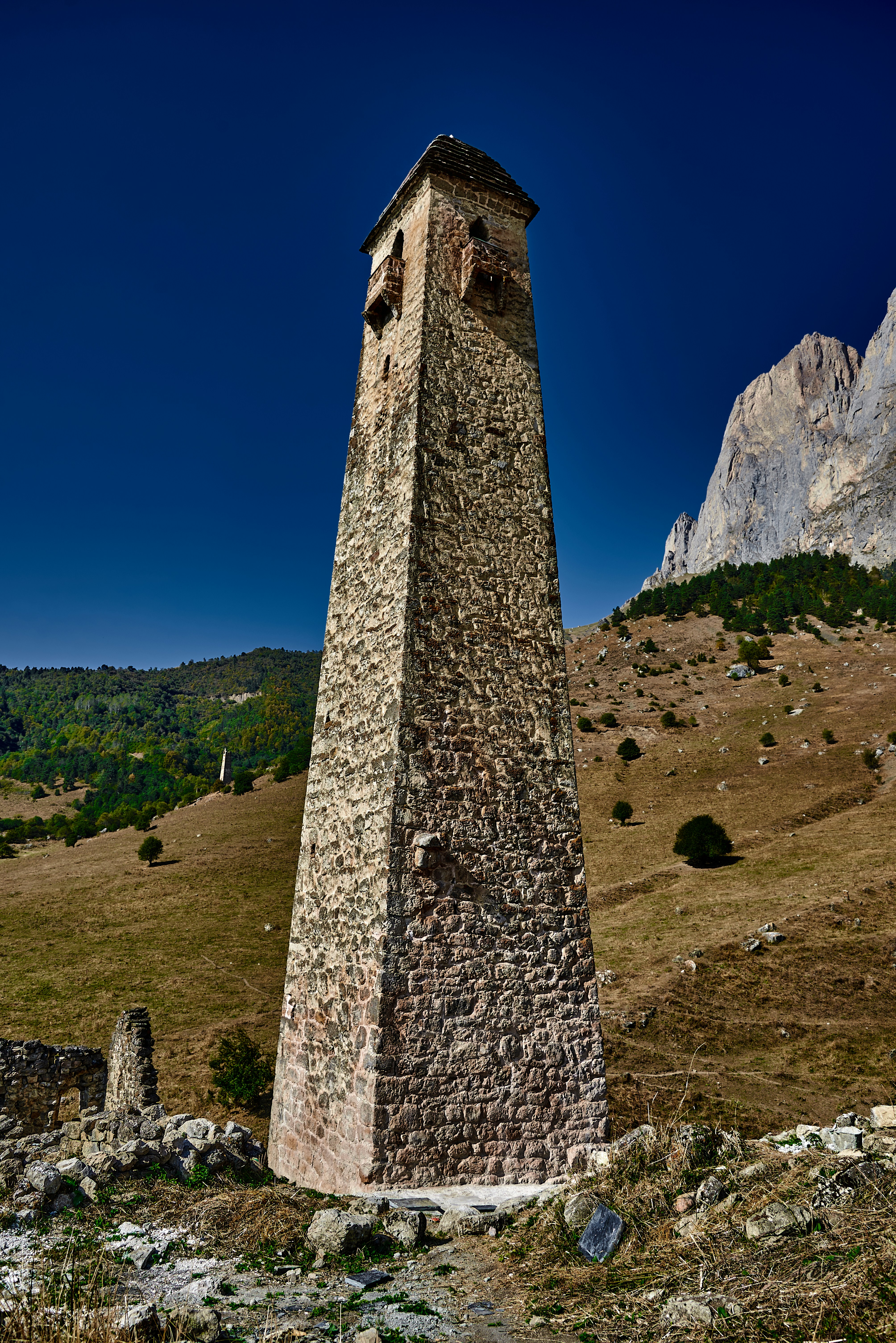 gray concrete tower on green grass field during daytime