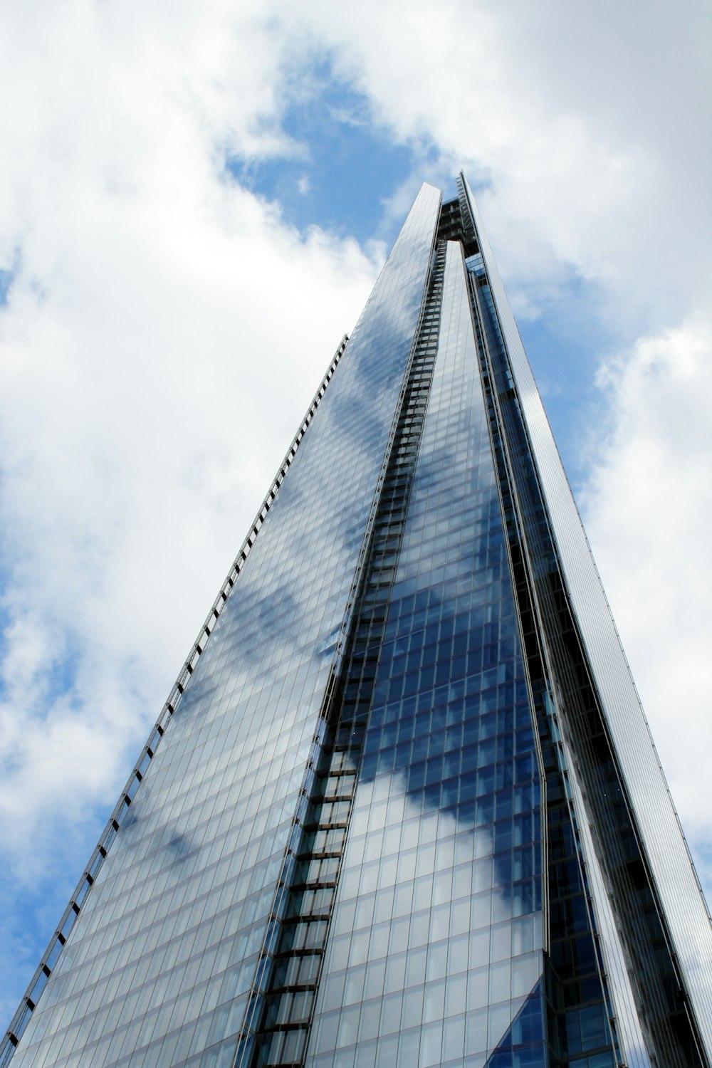 blue and white glass building under blue sky during daytime