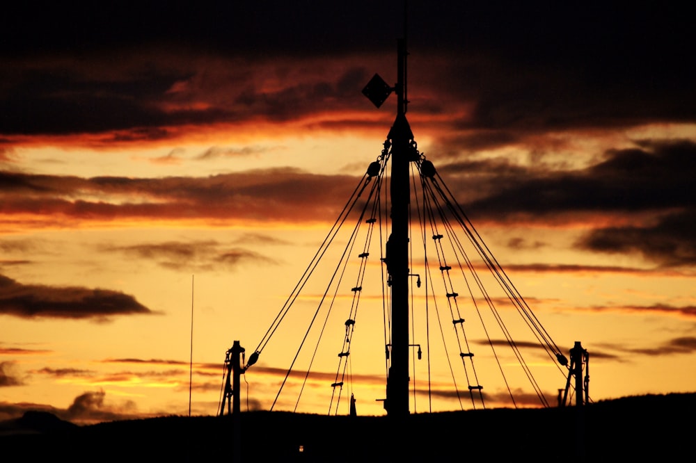 silhouette of people standing on bridge during sunset