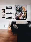 An artistic shot of a cozy room highlighting black furniture and golden decor.